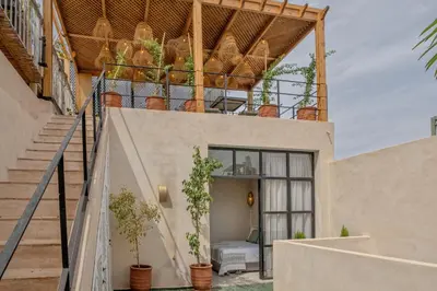 an external view of a house with stairs and potted plants at Riad Tassili Vert in Marrakech