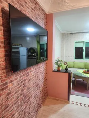 a brick wall with a mirror in a room at Appartement in Marrakech