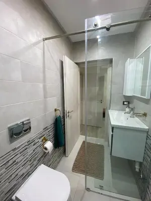 a bathroom with a shower and a toilet and a sink at KSYI IMMO 6 Marrakech Aéroport in Marrakech
