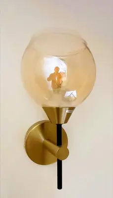 a light on a wall with a person on it at Riad Duplex de charme 2 chambres in Marrakech