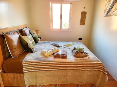 a bed with a tray of food on it at Riad Duplex de charme 2 chambres in Marrakech