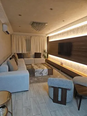 a living room with a couch and a tv at Yaza appartement in Marrakech