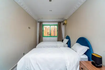 a bedroom with two beds and a window at Yaza appartement in Marrakech