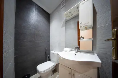a bathroom with a white toilet and a sink at Yaza appartement in Marrakech