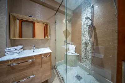 a bathroom with a shower and a sink and a glass shower stall at Yaza appartement in Marrakech