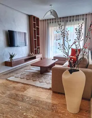 a living room with a large vase with a plant in it at Élégance & confort au centre ville de Marrakech in Marrakech