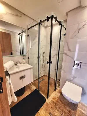 a bathroom with a shower and a toilet and a sink at Élégance & confort au centre ville de Marrakech in Marrakech