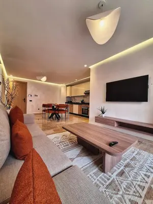 a living room with a couch and a flat screen tv at Élégance & confort au centre ville de Marrakech in Marrakech