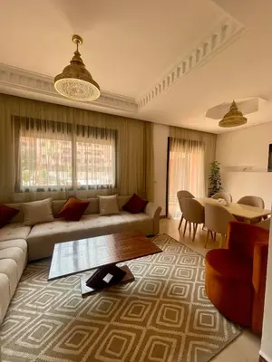 a living room with a couch and a table at Premium Village, appartement cosy in Marrakech