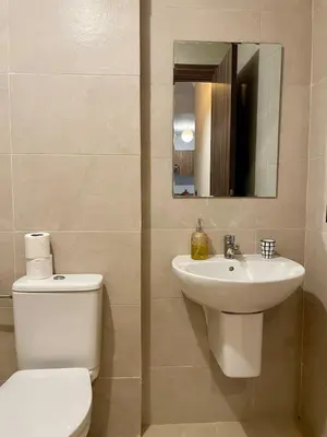 a bathroom with a toilet and a sink and a mirror at Cozy apartment with pool Downtown Marrakech in Marrakech