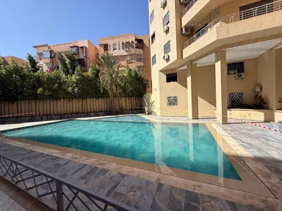 a swimming pool in front of a building at Burj Malak Comfort and Pool in Marrakech