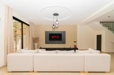 a white couch in a living room with a tv at Villa NAYA in Marrakech