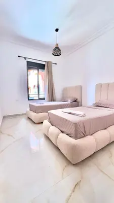 a bedroom with two beds and a window at Marrakech Luxury Apartment with Pool & gym in Marrakech
