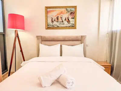 a bedroom with a bed with a towel on it at Central Apartment in Gueliz Steps from Carré Eden in Marrakech