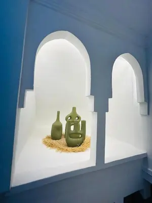 two green vases sitting on a shelf in a room at Riad Hami in Marrakech