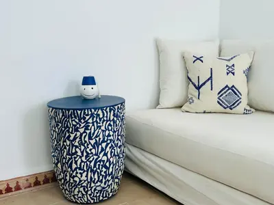 a white couch with a blue and white table at Riad Hami in Marrakech