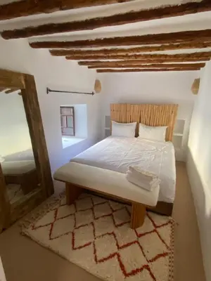 a bedroom with a white bed with a wooden headboard at Riad Elena l Private Riad with heated Pool in Marrakech l 3 rooms in Marrakech