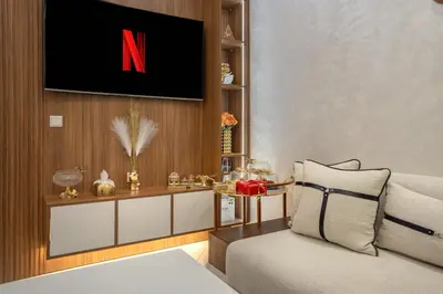 a living room with a n on the wall at Titrit Apartment Marrakech in Marrakech