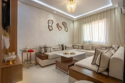 a living room with a couch and a table at Titrit Apartment Marrakech in Marrakech