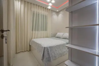 a small bedroom with a bed and a window at Titrit Apartment Marrakech in Marrakech
