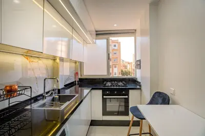 a kitchen with a sink and a stove at Titrit Apartment Marrakech in Marrakech