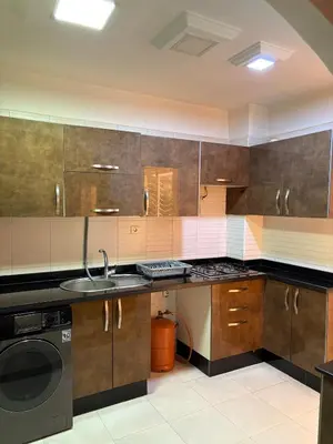 a kitchen with a sink and a washing machine at Appartement 85m dans un quartier calme in Marrakech