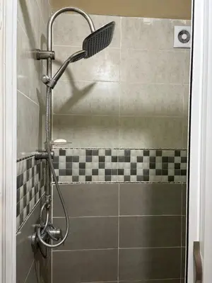 a shower with a shower head in a bathroom at Appartement 85m dans un quartier calme in Marrakech