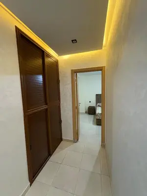 a hallway with a door and a room with a bedroom at Appartement 85m dans un quartier calme in Marrakech