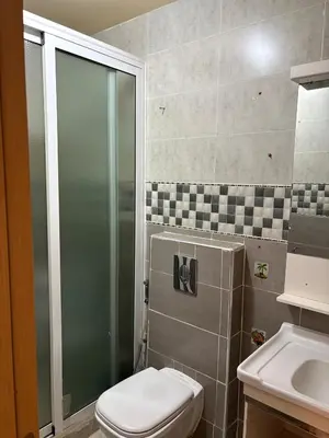 a bathroom with a shower and a toilet and a sink at Appartement 85m dans un quartier calme in Marrakech