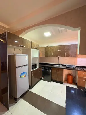a kitchen with a refrigerator and a dishwasher at Appartement 85m dans un quartier calme in Marrakech