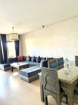 a living room with a couch and a table at Prestigia jade in Marrakech