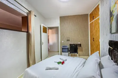 a bedroom with a white bed with flowers on it at Stylish Apartment in Gueliz by Train & Majorelle in Marrakech