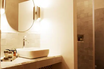 a bathroom with a white sink and a mirror at Riad RK Suites & Spa in Marrakech