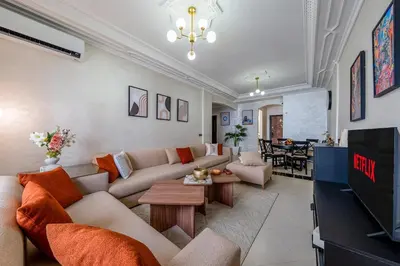 a living room with a couch and a tv at Cozy apartment, 2 bedrooms, 10 min from airport and Medina in Marrakech