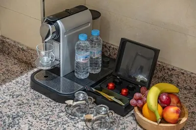 a kitchen counter with a drink maker and a bowl of fruit at Cozy apartment, 2 bedrooms, 10 min from airport and Medina in Marrakech