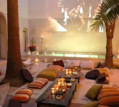 a living room with a lot of pillows and candles at Riad 144 in Marrakech