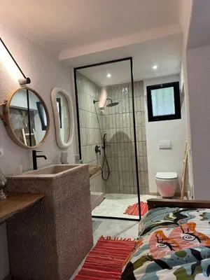 a bathroom with a bed and a sink and a shower at Villa en centre Ville de Marrakech, 5 Chambres, Piscine, Rooftop in Marrakech
