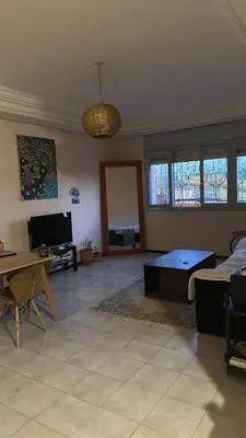 a living room with a couch and a table at KueerLand Home for All kueer Travelers in Marrakech