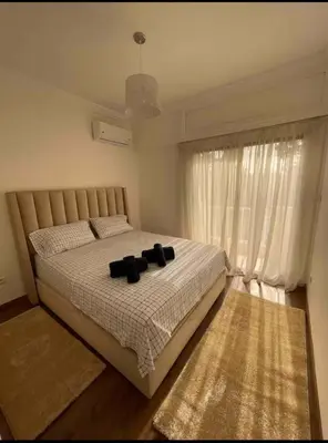 a bedroom with a bed with black pillows on it at Blue Majorelle in Marrakech