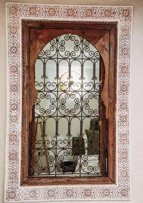 a window with a iron gate on a wall at Riad Dar Lghizlane in Marrakech