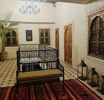 a room with a bed and some wooden doors at Riad Dar Lghizlane in Marrakech