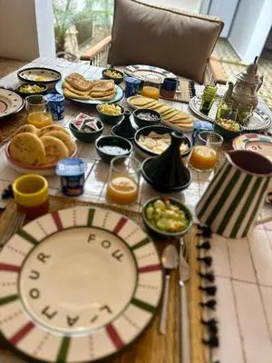 a table with plates of food on top of it at Riad MONA Marrakech Kasbah Médina in Marrakech