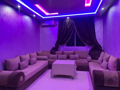 a purple living room with a couch and a table at AJ Apartment Ideal for Families, Married Couples, and Solo Travelers in Marrakech