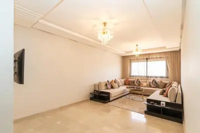 a living room with a couch and a tv at Beautiful accommodation with 2 pools & fast WiFi in Marrakech