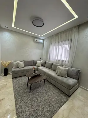 a living room with a couch and a table at Studio Jasmine in Marrakech