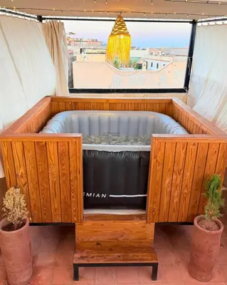 a hot tub in a room with a window at Dar Skouri in Marrakech