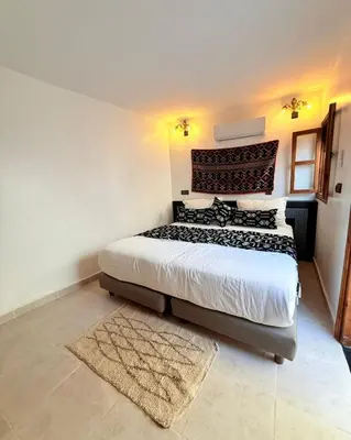 a bedroom with a large bed in a room at Dar Skouri in Marrakech