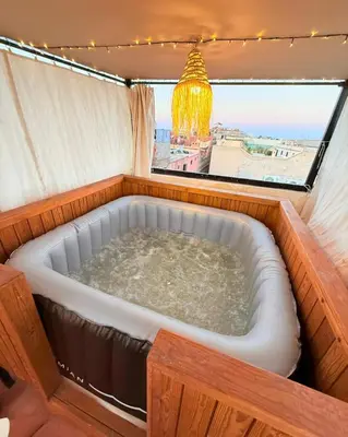 a hot tub in a room with a window at Dar Skouri in Marrakech