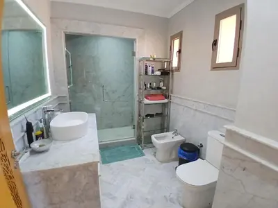 a bathroom with a shower and a toilet and a sink at Villa Zohra in Marrakech