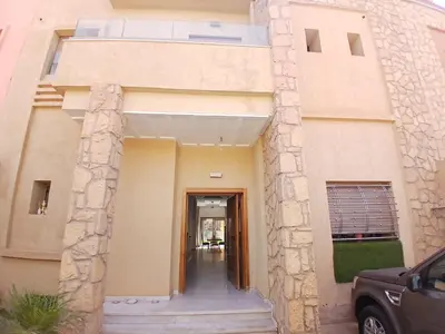 a building with a hallway leading to a door at Villa Zohra in Marrakech